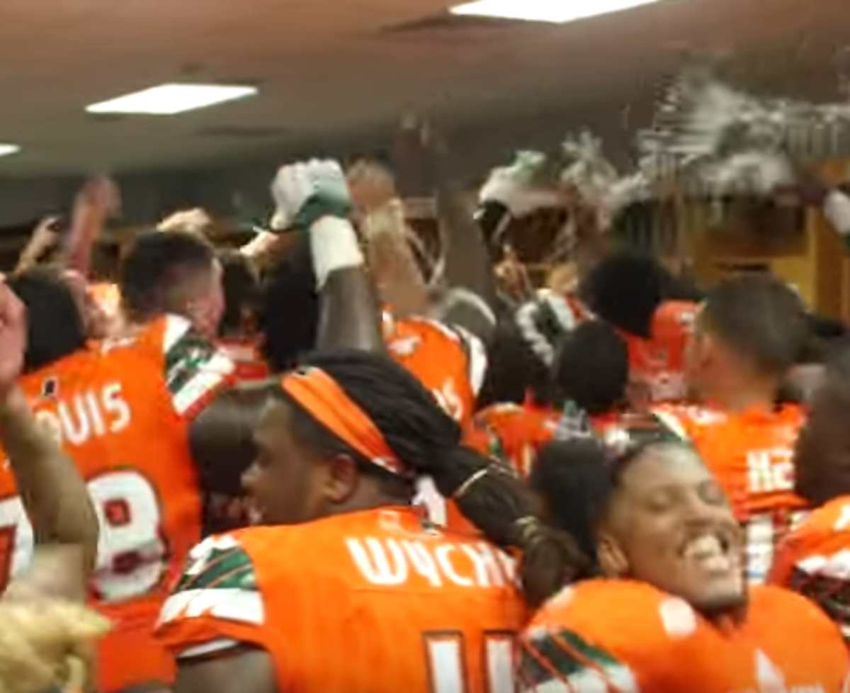 Miami Hurricane players celebrate a win against Nebraska in the locker room.