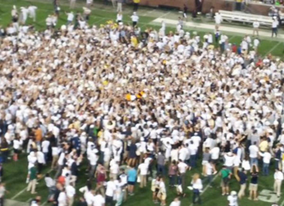 Georgia Tech fans rushing the field after last second win.
