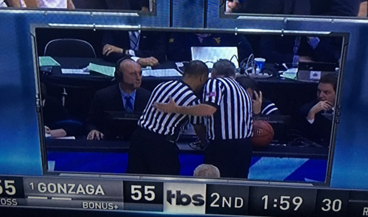 officials review a play during the gonzaga west virginia game.