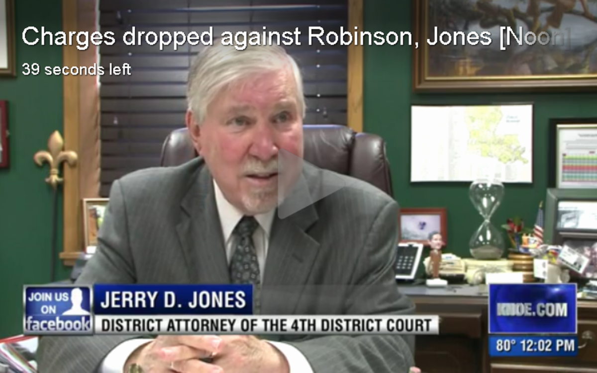 District Attorney Jerry D. Jones at his desk discussing the dropped charges of Alabama football players.
