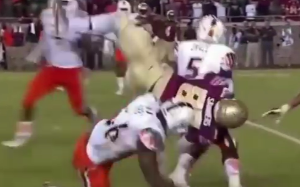 Miami player levels a Florida State player.