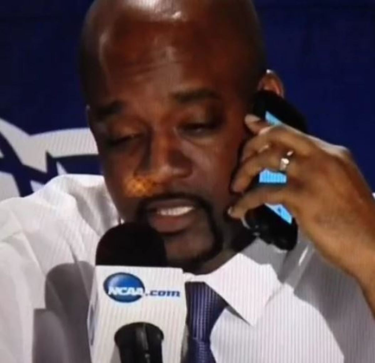 Hampton head coach Edward Joyner on his phone.