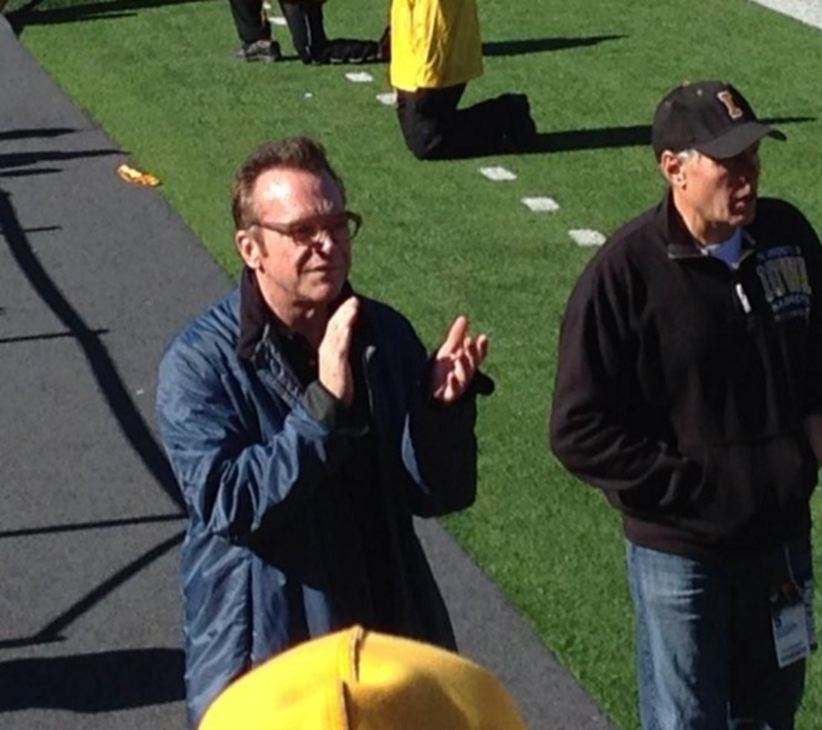 Tom Arnold claps for Iowa football.