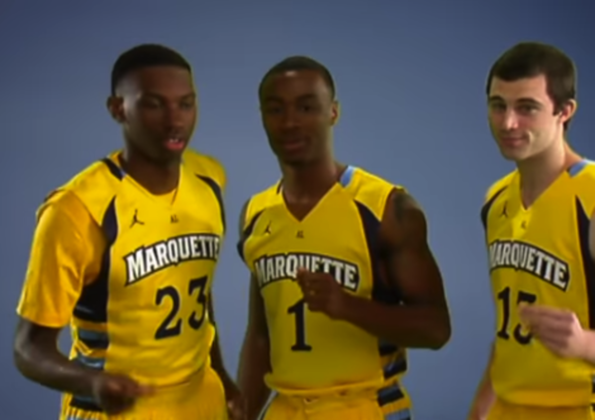 Marquette basketball players in yellow jerseys.