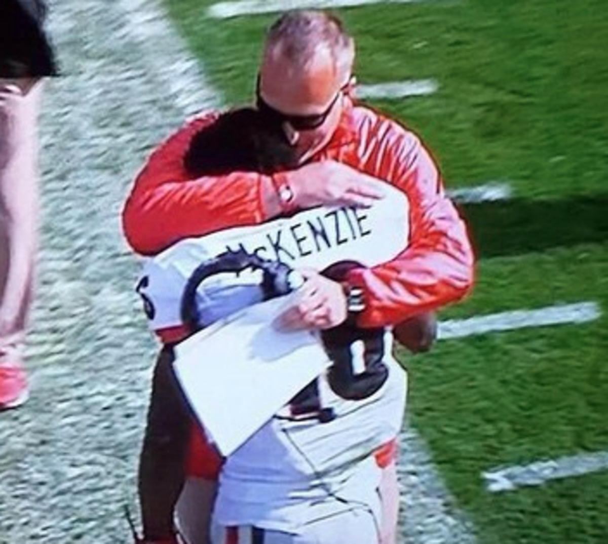 Isaiah McKenzie embraces his coach on the sideline.