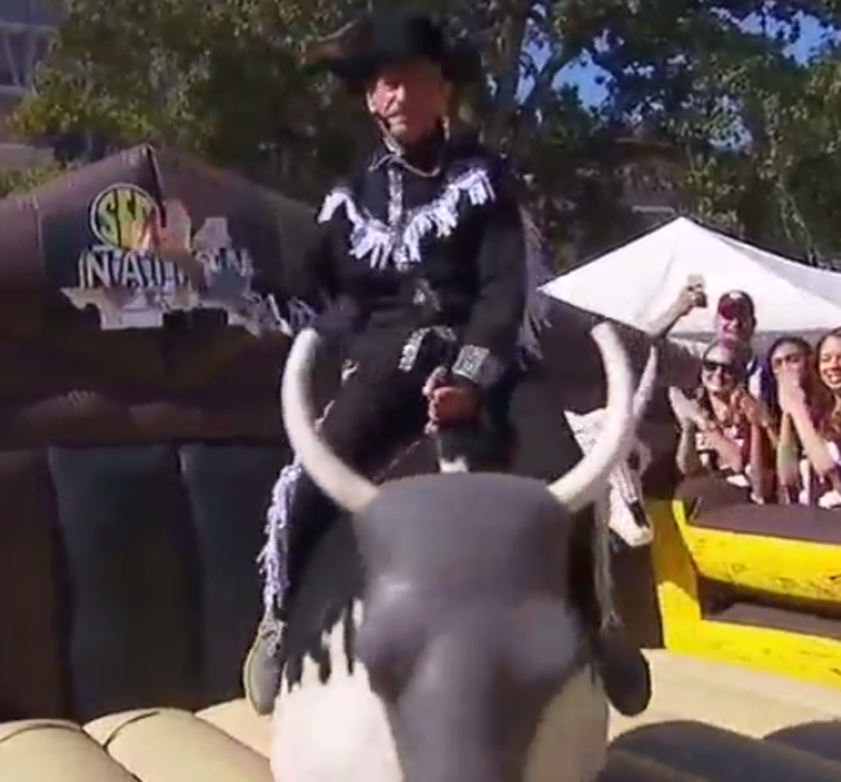 Paul Finebaum riding a mechanical bull.