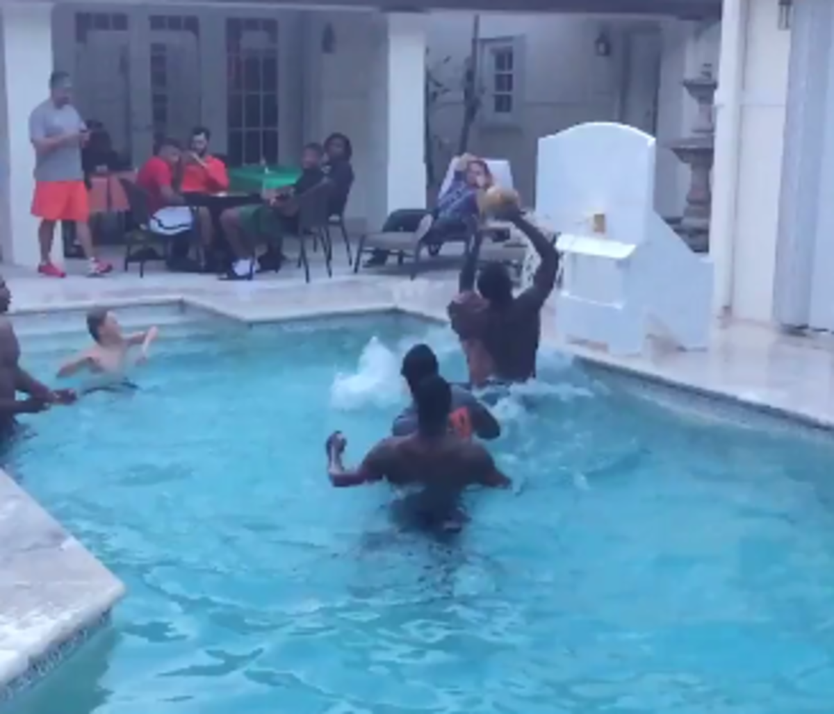 Miami al golden plays basketball in his pool with teammates.