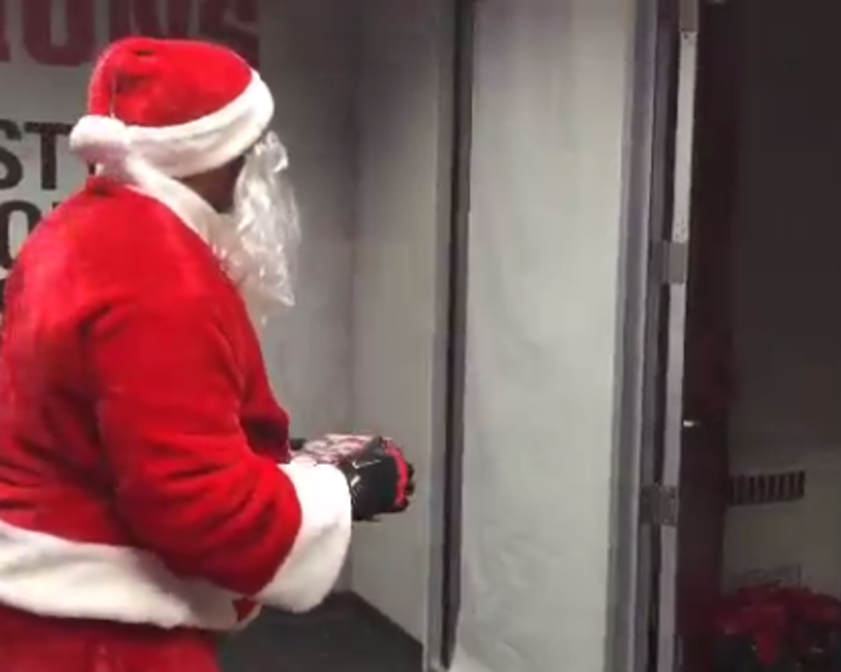 Santa surprises Urban Meyer at the OSU facility.
