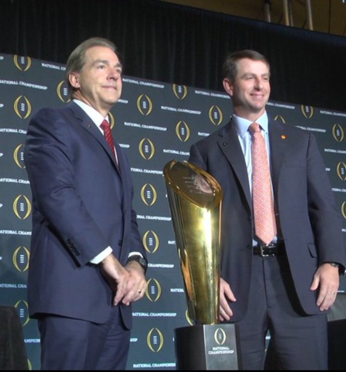 Dabo Swinney and Nick Saban pose with the College Football Playoff national title trophy.