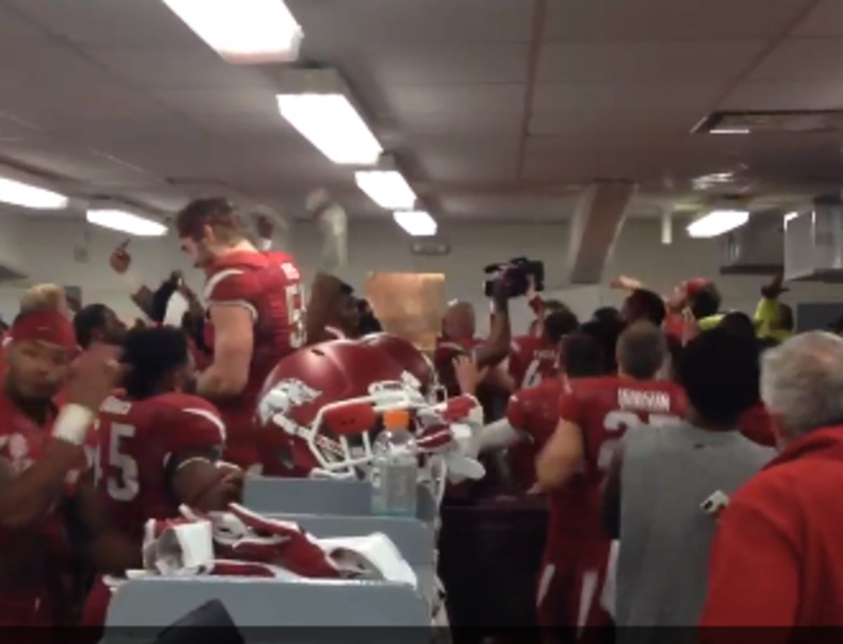 Arkansas celebrates and sings in the locker room after beating LSU.