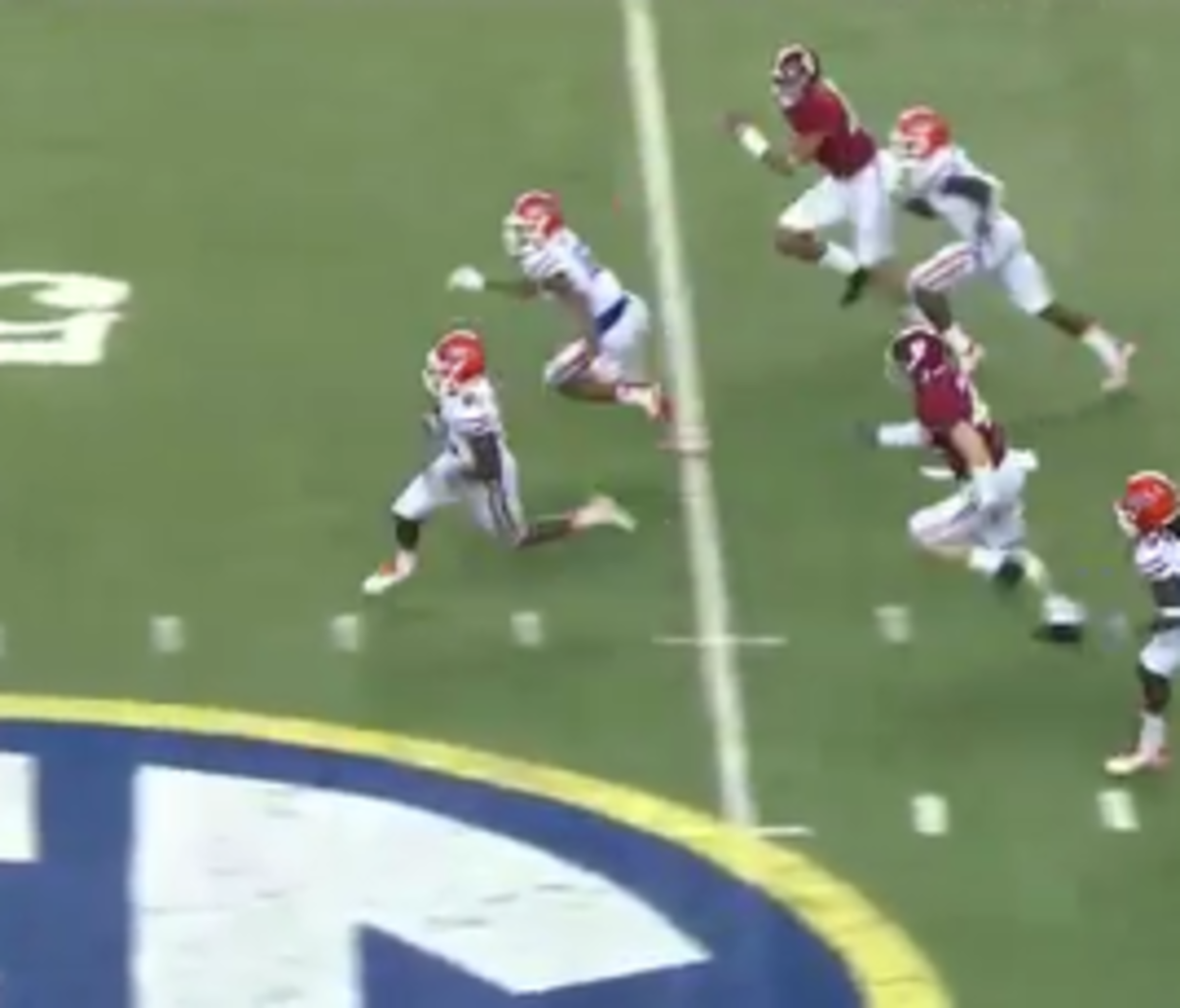 Antonio Callaway runs away from Alabama defenders on his way to the endzone.