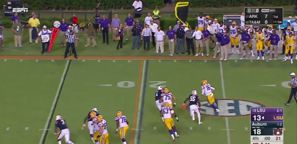 LSU QB running away from Auburn players as time expires.