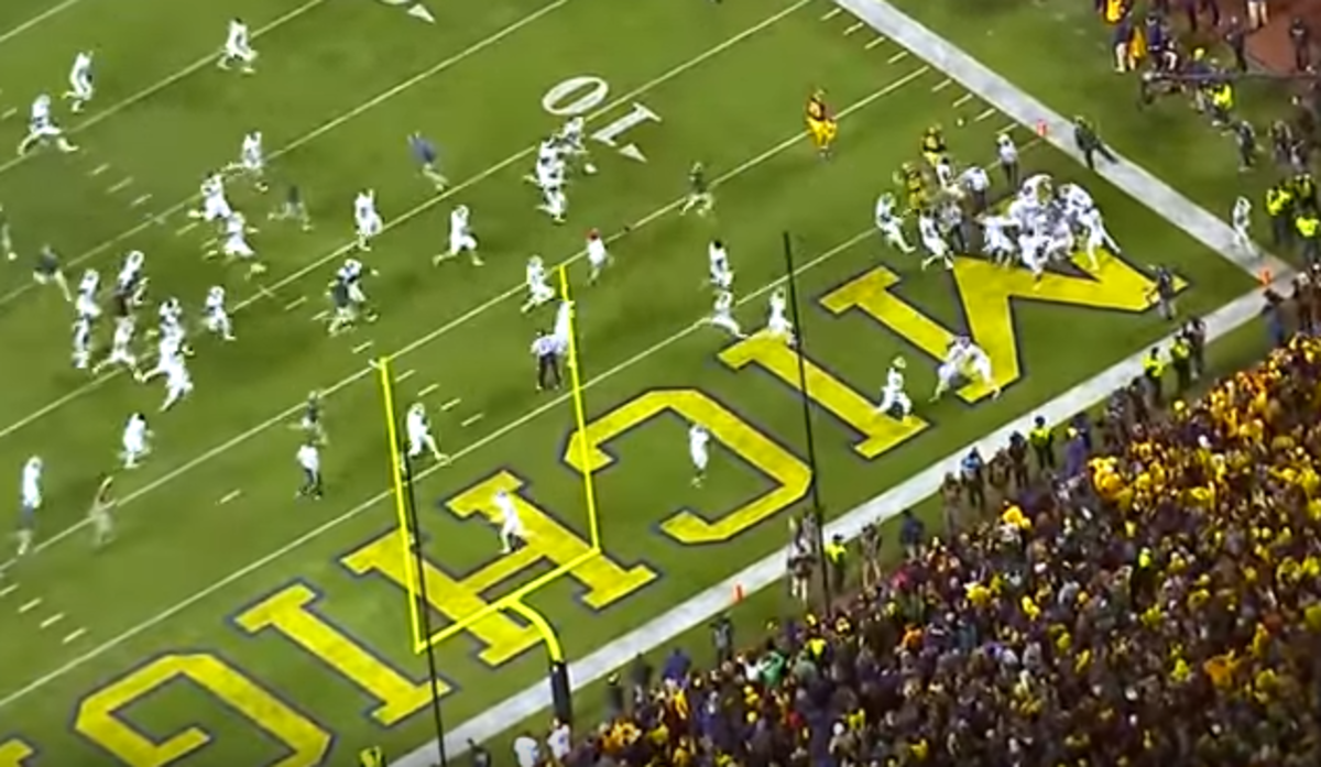 Michigan State payers rush the field against Michigan State.