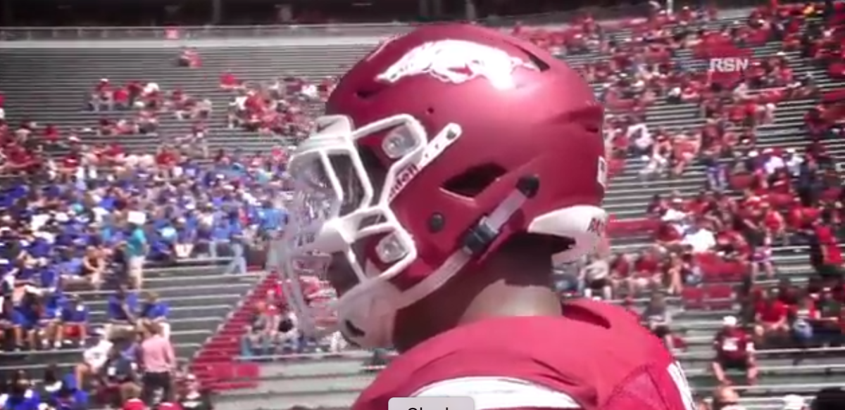A side view of an Arkansas player wearing a helmet