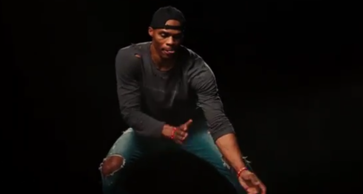 Russell Westbrook in front of a black background in a Jordan commercial.