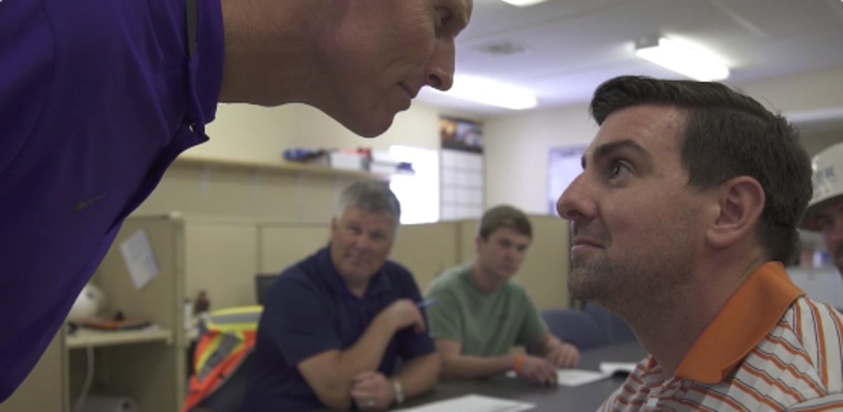 Brent Venables stares into a mans eyes.