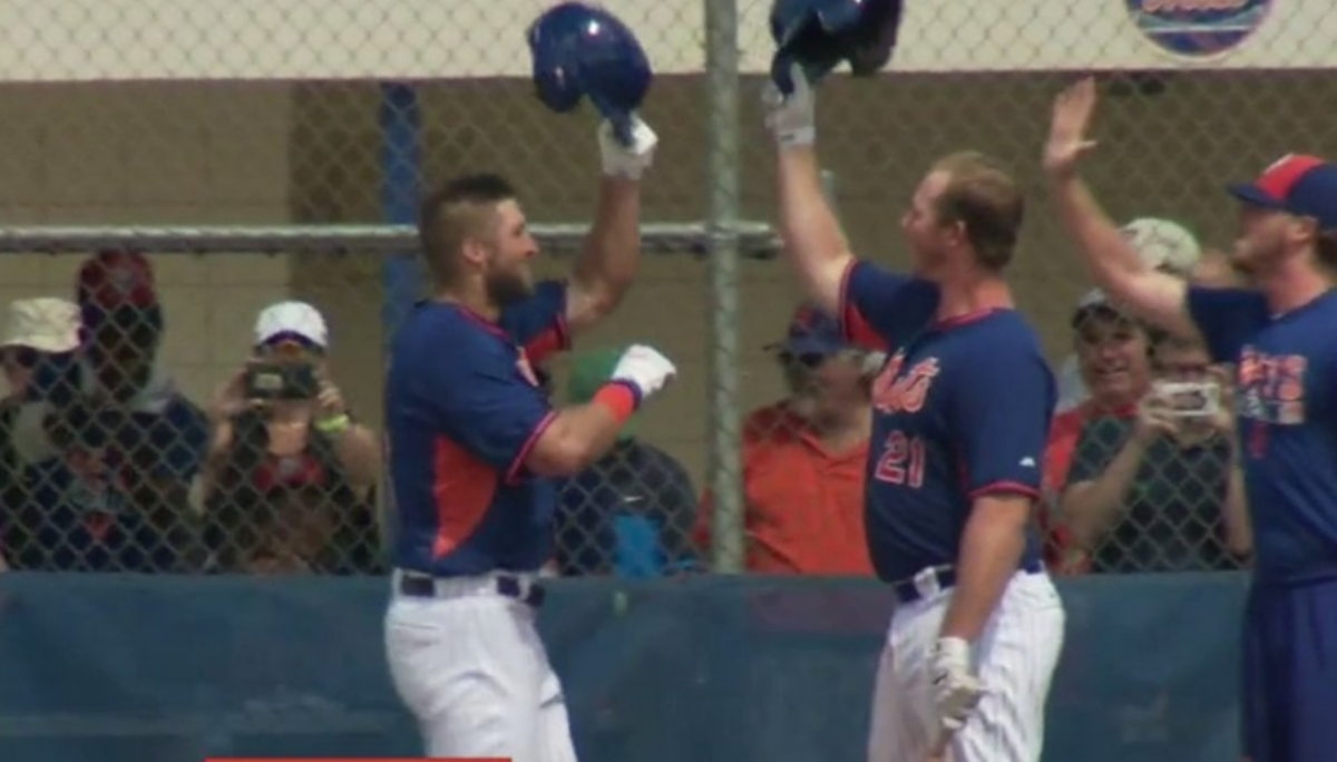 Tim Tebow celebrating a home run with his teammates.