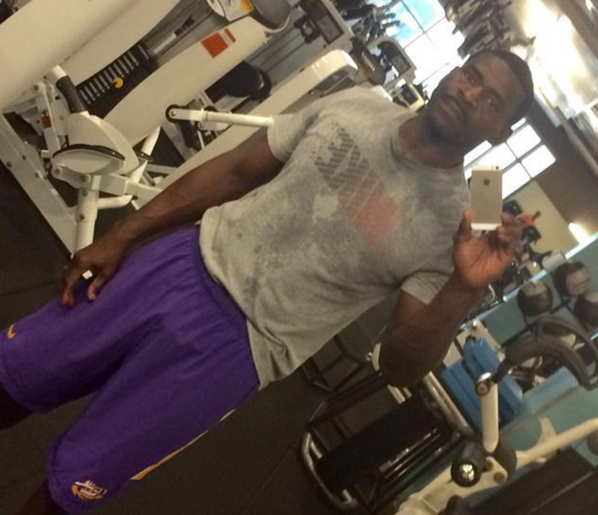 Michael Irvin taking a selfie in LSU shorts after losing a bet.