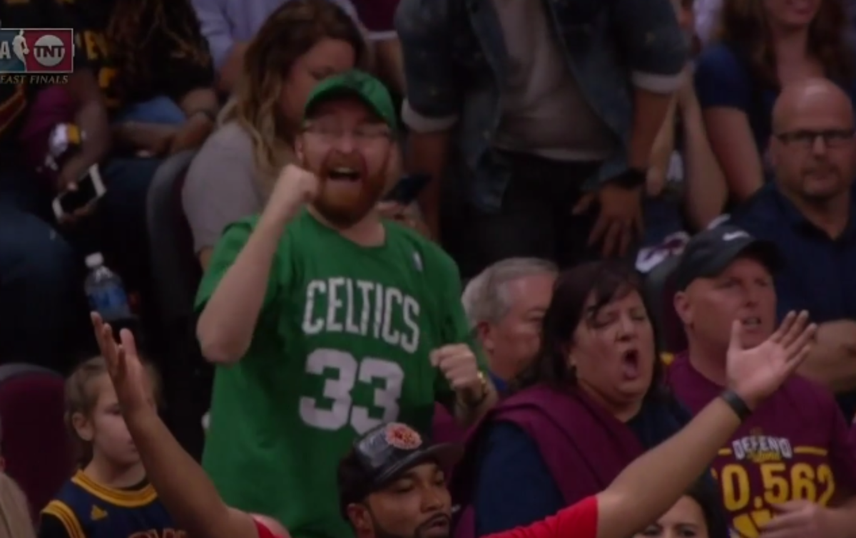 A Celtics fan cheers in the crowd.