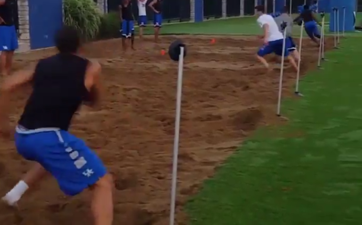 Kentucky Basketball players do a workout in the sand.