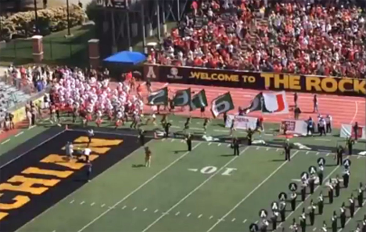 Miami Hurricanes players marching onto Appalachian State's field.