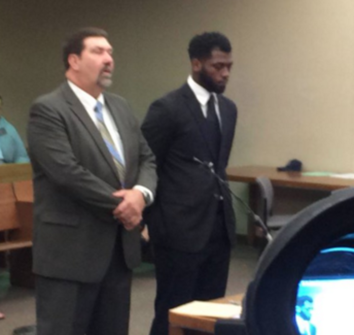 JT Barrett stands with a man in court.
