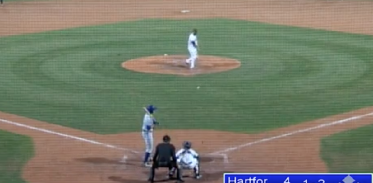 A minor league pitcher strikes out a hitter.