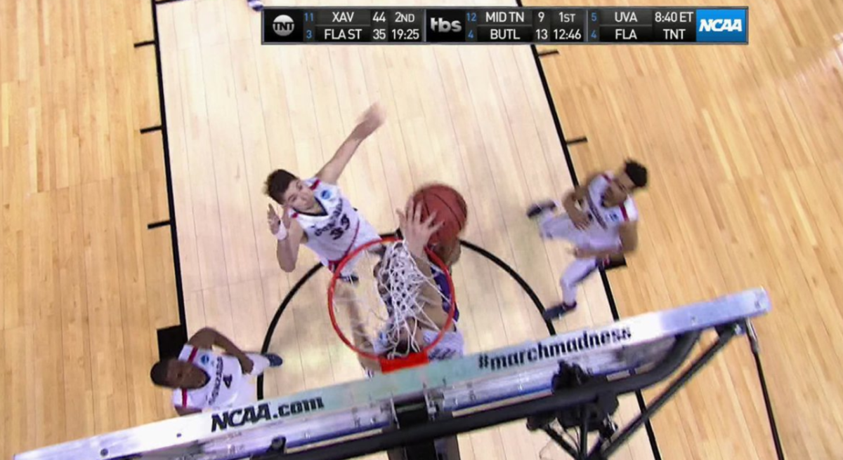 Northwestern and Gonzaga players battle for a rebound.