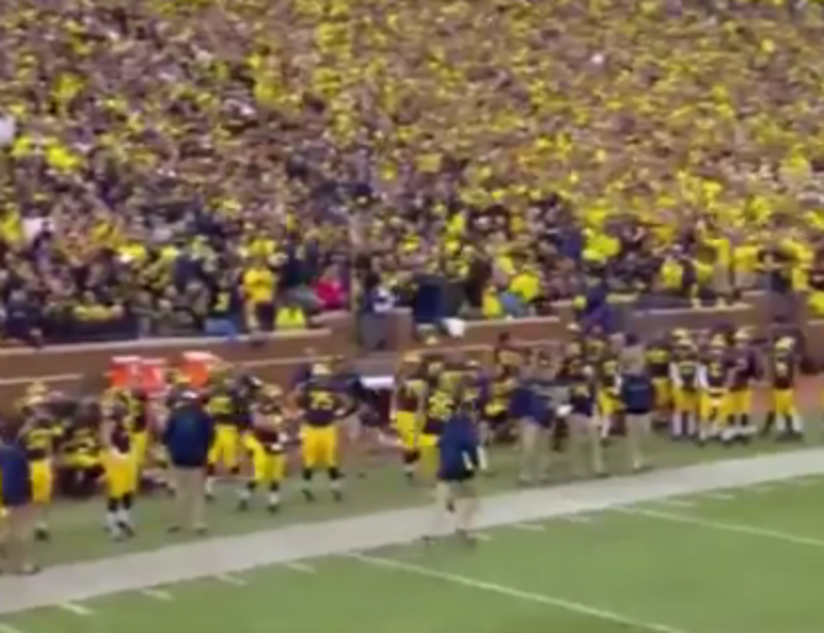 Joe Bolden runs off the field pumping up the Michigan crowd.