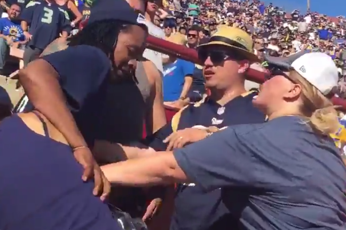 A Seahawks fan getting into it with a Rams fan.