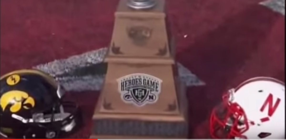 Iowa and Nebraska helmets are seen next to the Heroes Game trophy.