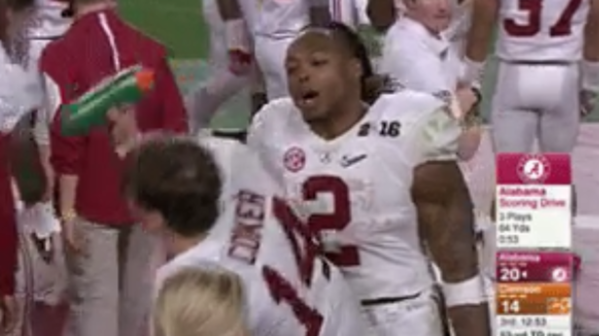 Jake Coker tries to drink while Derrick Henry yells at him.