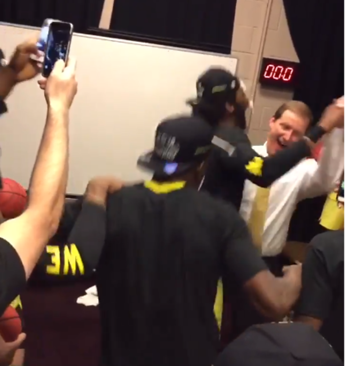 Oregon players and coaches celebrate in the locker room after PAC 12 title.