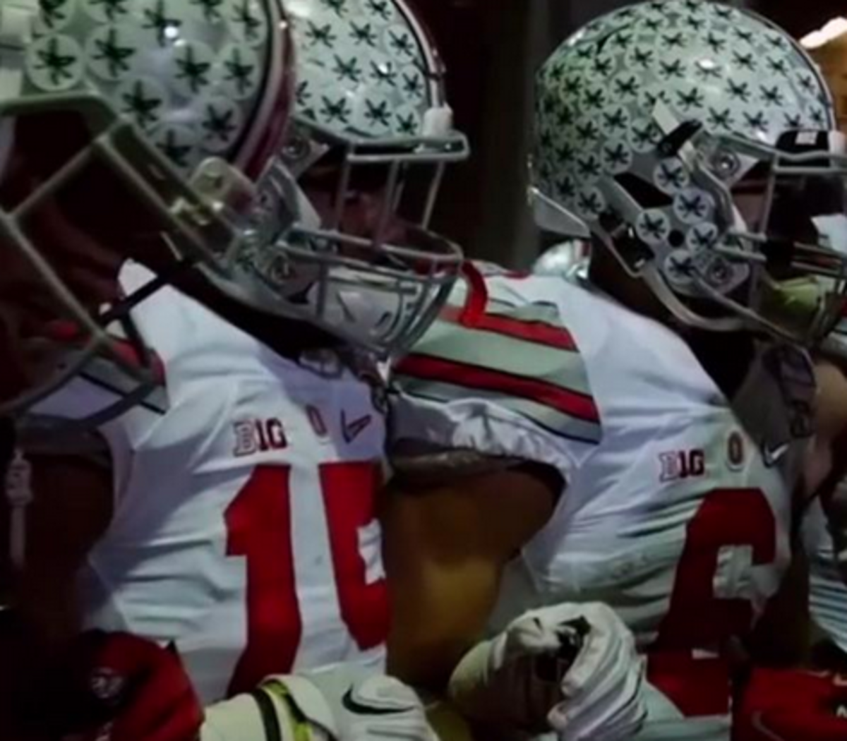 Ohio State players link arms before a game.