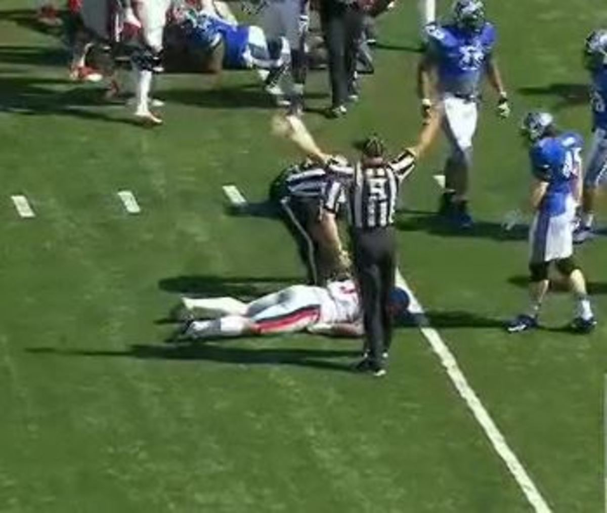 Robert Nkemdiche lays face down on the field after suffering a concussion.