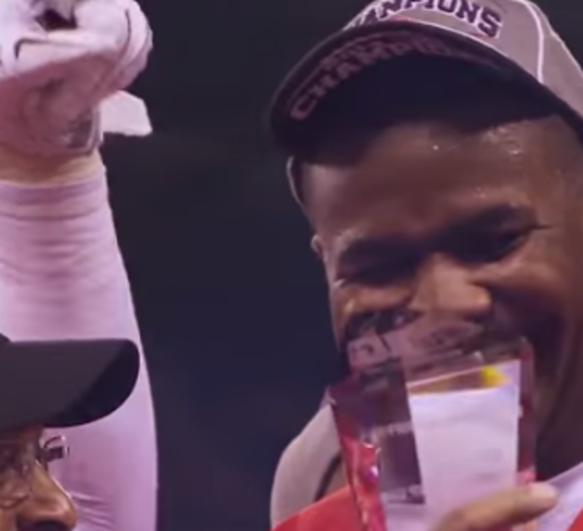 Cardale Jones smiles holding a trophy.