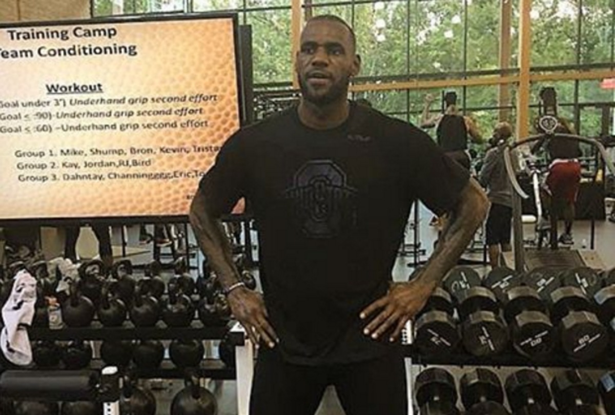 LeBron James wearing an Ohio State shirt while in a weight room.