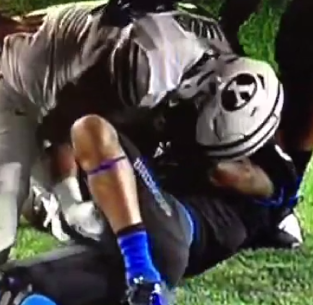BYU player lays on top of an opponent.
