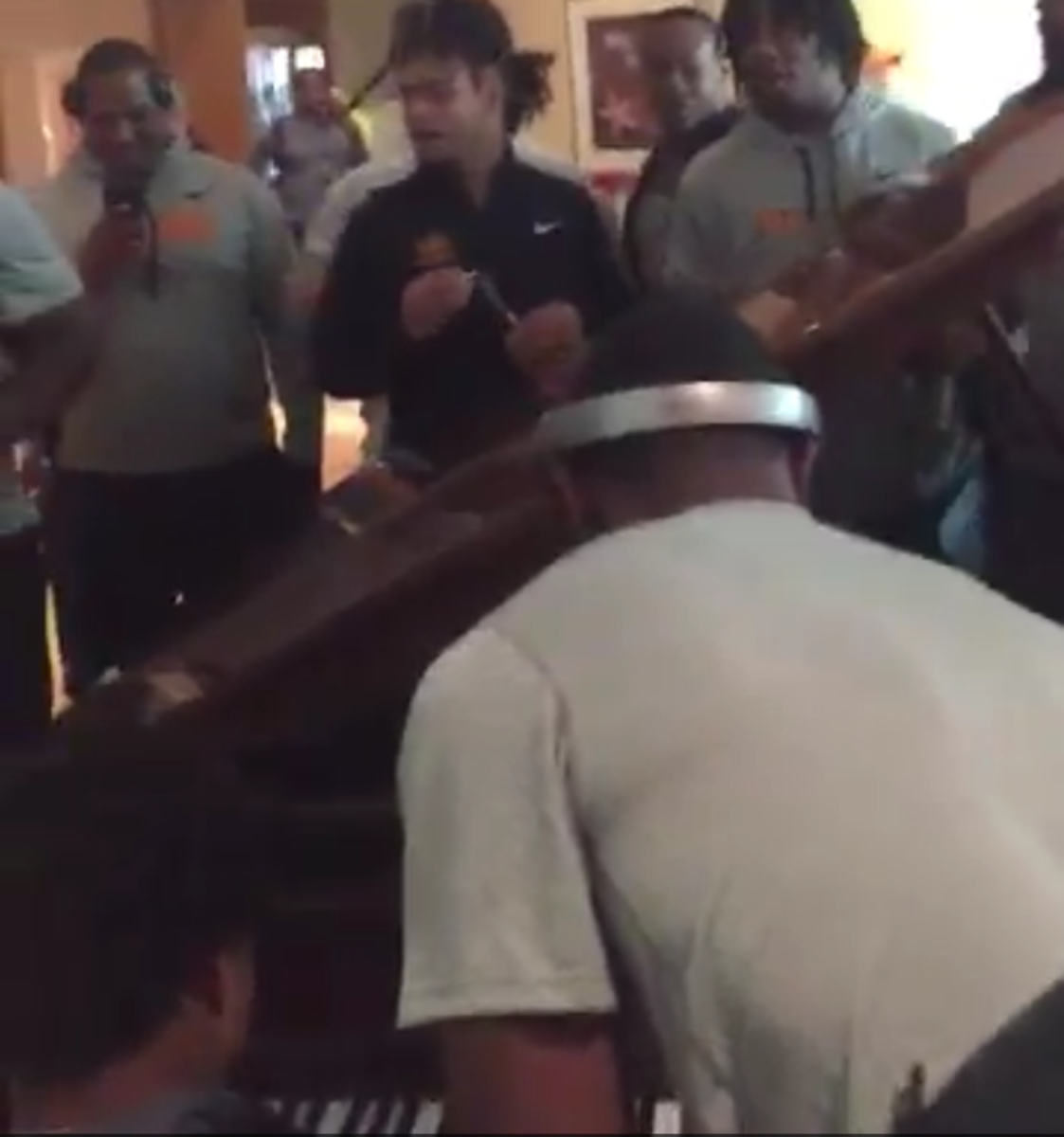 Tennessee players surround the piano for a performance of "Lean on Me".