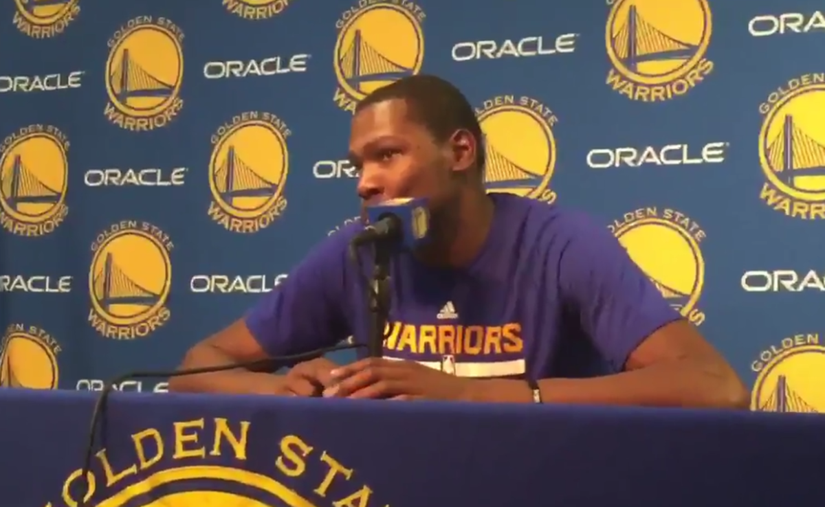 Kevin Durant answers questions at the podium.