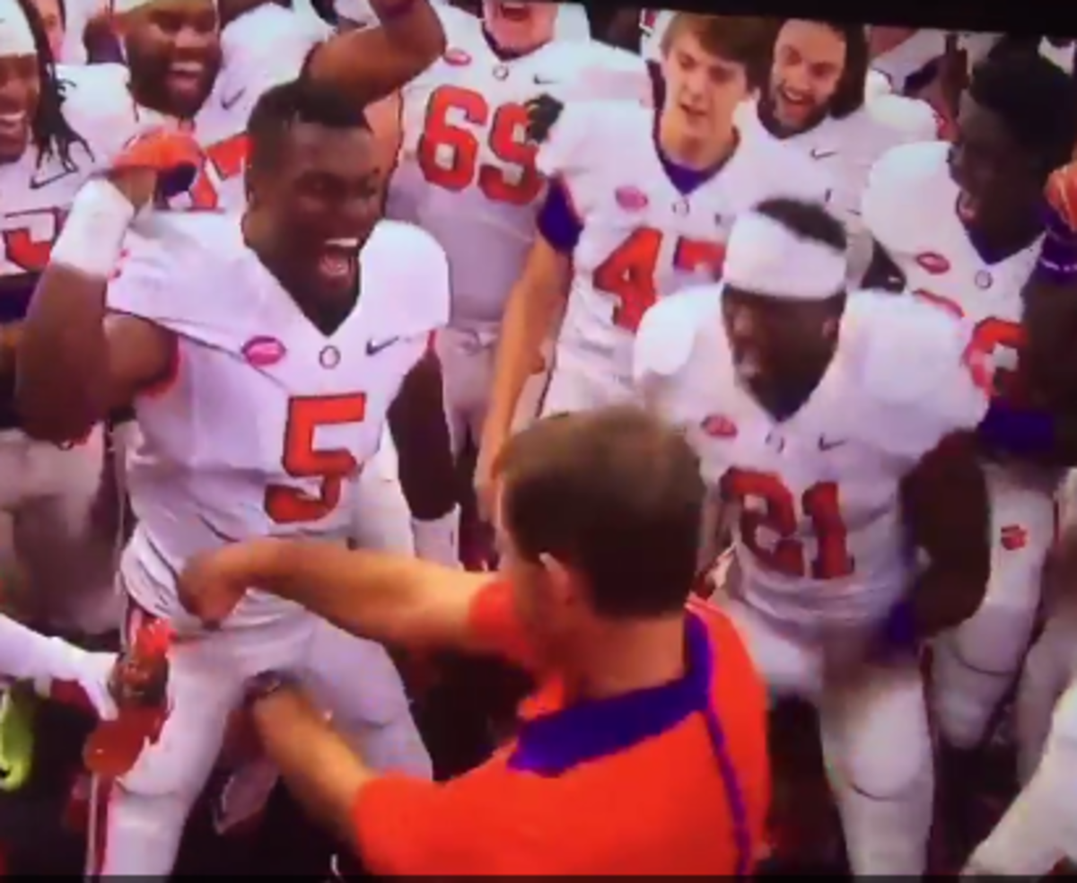 Clemson head coach Dabo Swinney attempting the "whip" in the locker room after beating Louisville.