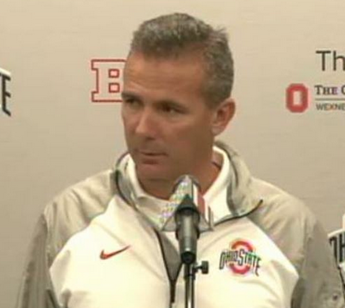 Urban Meyer talks about the quarterback situation at a press conference.