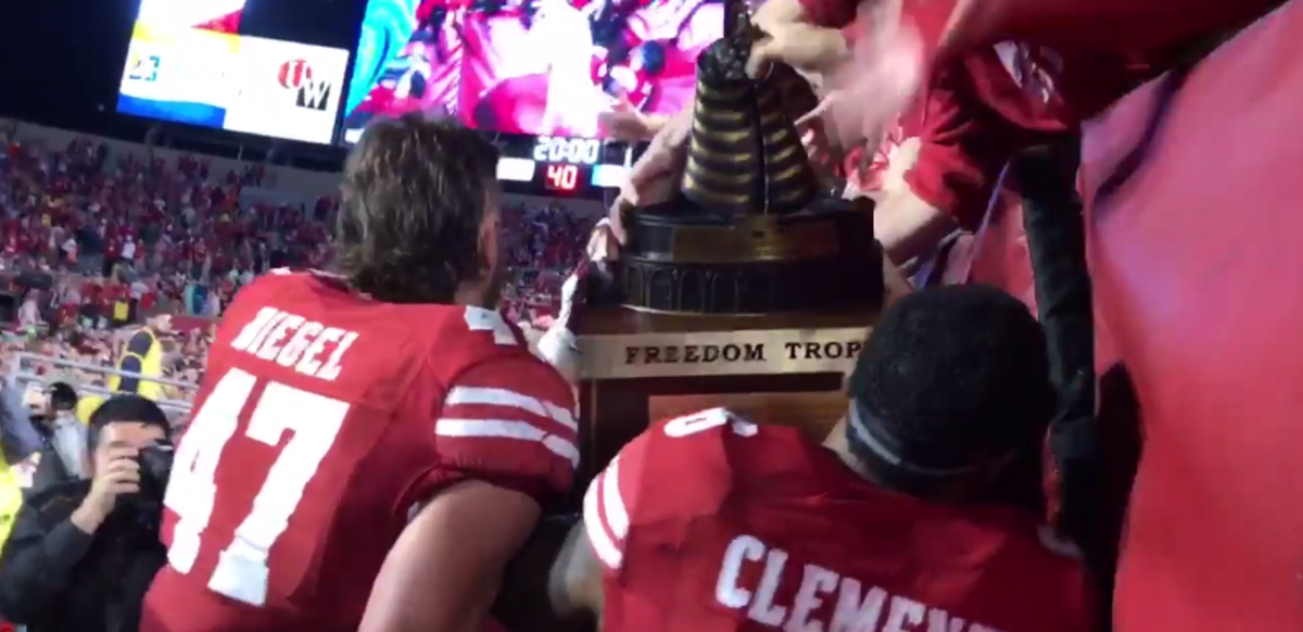 Wisconsin players carrying the Freedom Trophy after a win over Nebraska.