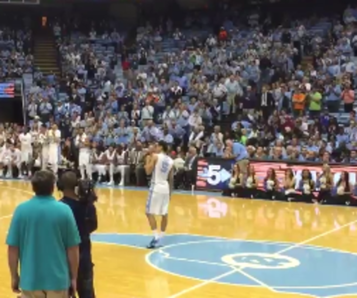 Marcus Paige delivers a speech at midcourt.