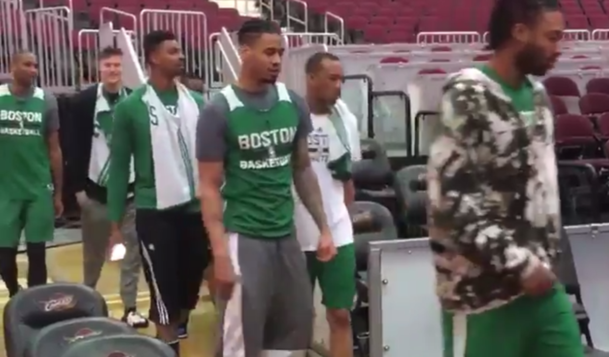 Celtics players walking on the court.