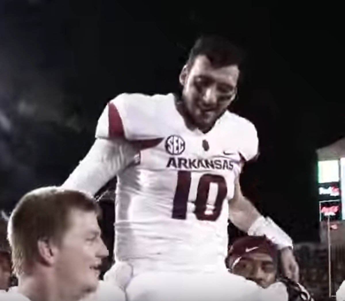 Arkansas player getting carried off the field after a big win.