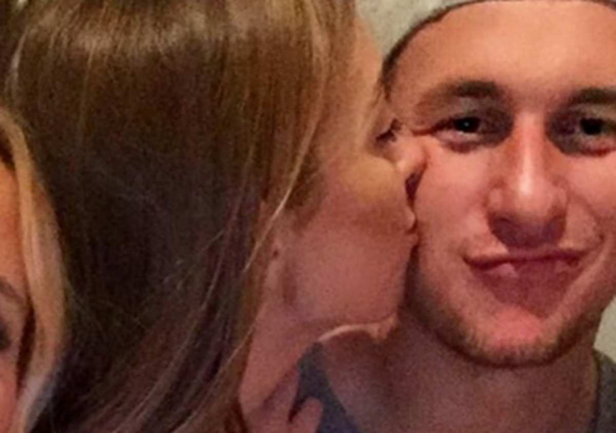 Johnny Manziel gets kissed on the cheek.