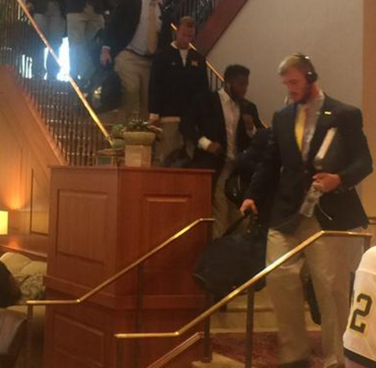 Michigan football players making their way down the stairs.