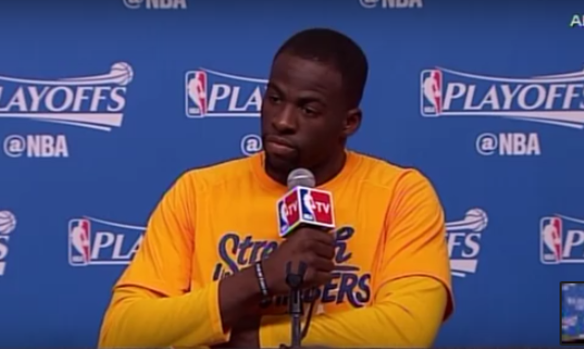 Draymond Green talks to reporter at a press conference.