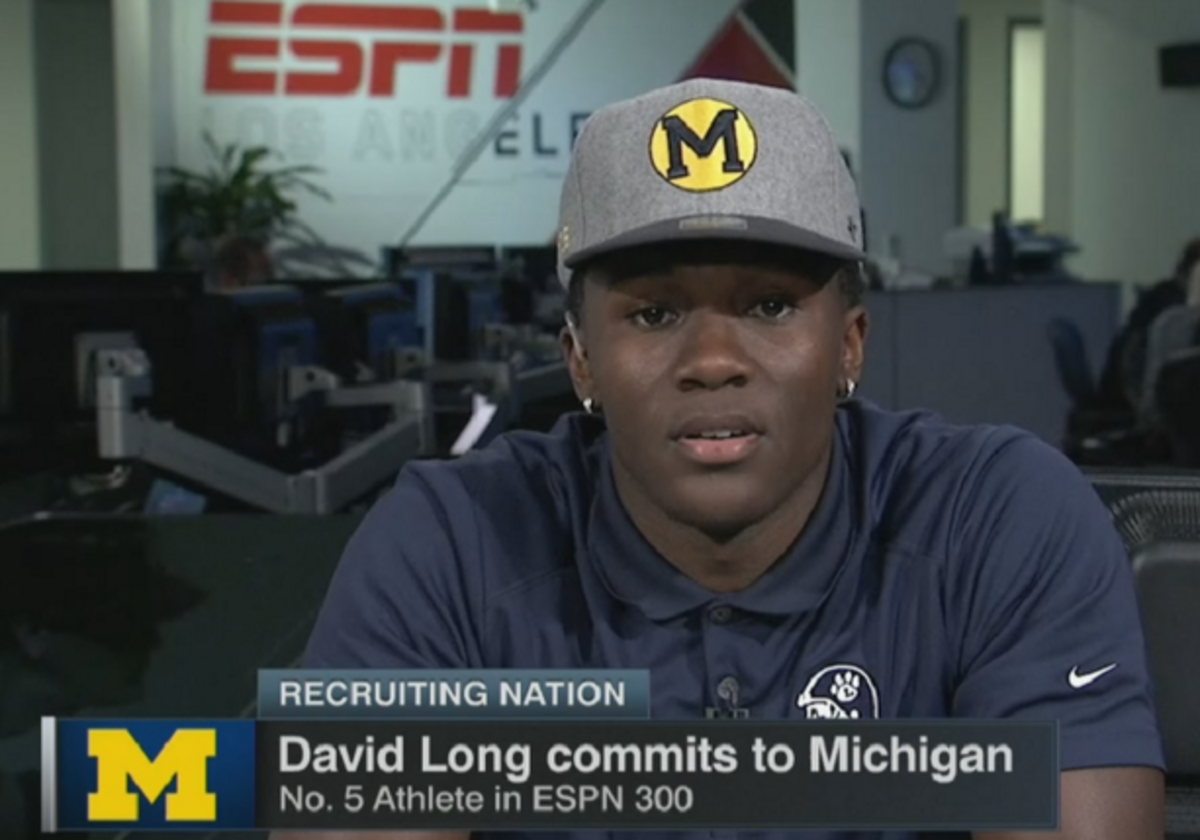 David Long on television with a Michigan hat.